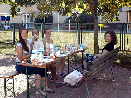 Carine. Augusto, Malin and Marlen outside having breakfast